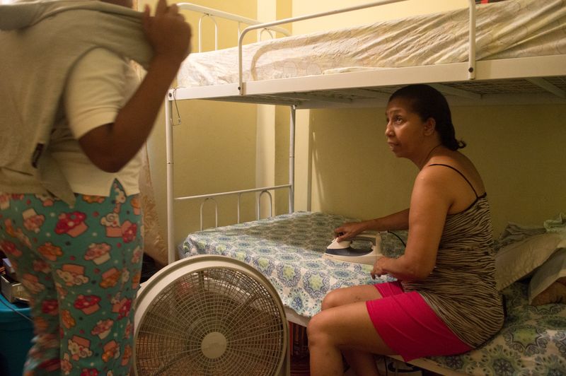 © Johanne Rahaman - My sister Dianne Miller irons for her granddaughter Mya, as she prepares her for school. San Juan,Trinidad 2016