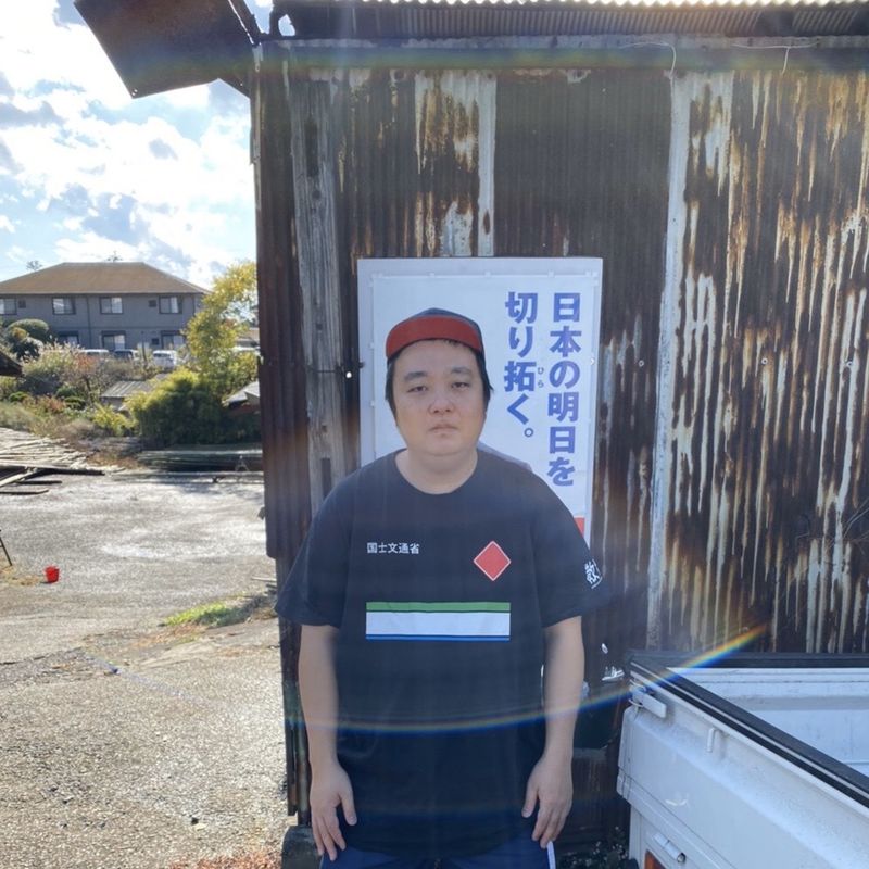 © Inokuchi Masashi - Probaganda Hero Standing in front of political advertising poster, asserting message
