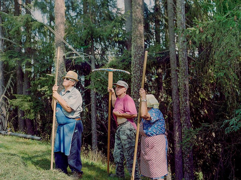 © Claudia Mann - Emilo, Heinrich and Monica Pallestrong take stock of how to rake hay down the mountain on their property in Rina.