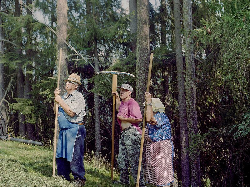 © Claudia Mann - Emilo, Heinrich and Monica Pallestrong take stock of how to rake hay down the mountain on their property in Rina.