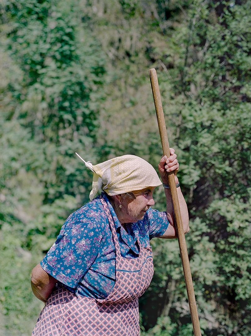 © Claudia Mann - Monica Pallestrong, 84, rests on the first day of collecting hay on her property in Rina.