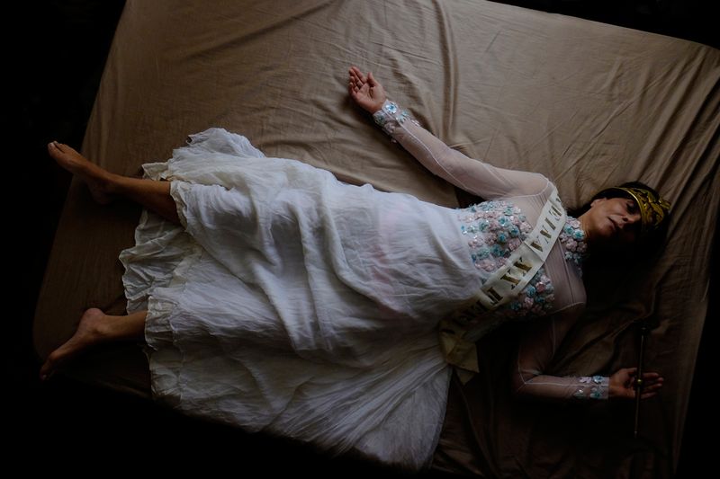 © Santiago Escobar-Jaramillo - My mother wearing the dress lies on the bed. 2016.
