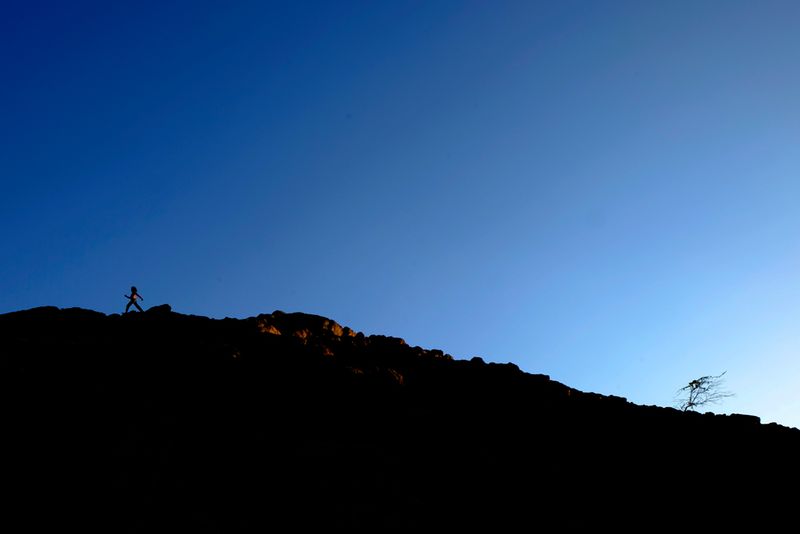 © Santiago Escobar-Jaramillo - A bush chases a girl in the dessert of High Guajira. The climate change chases humanity.