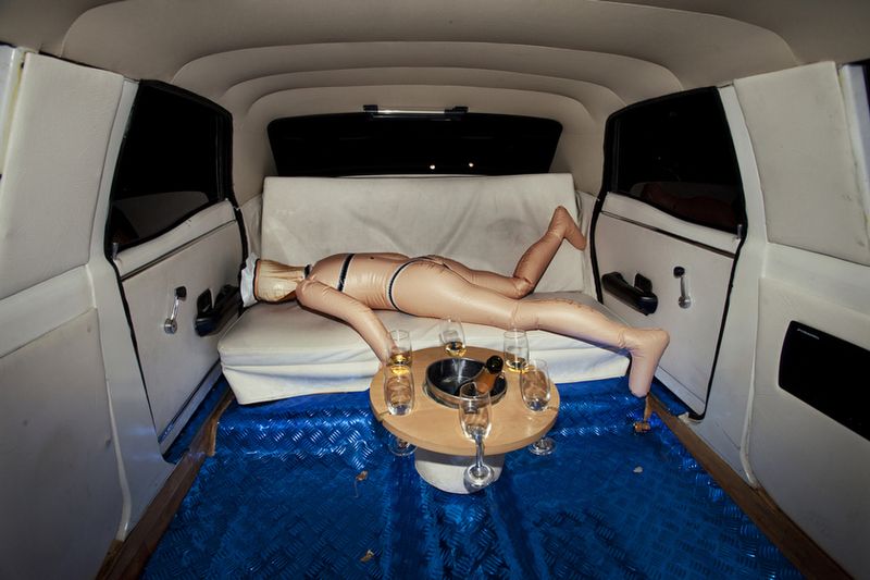 © Myriam Meloni - An inflatable doll forgotten in the seats of the limousine after a limousine party.