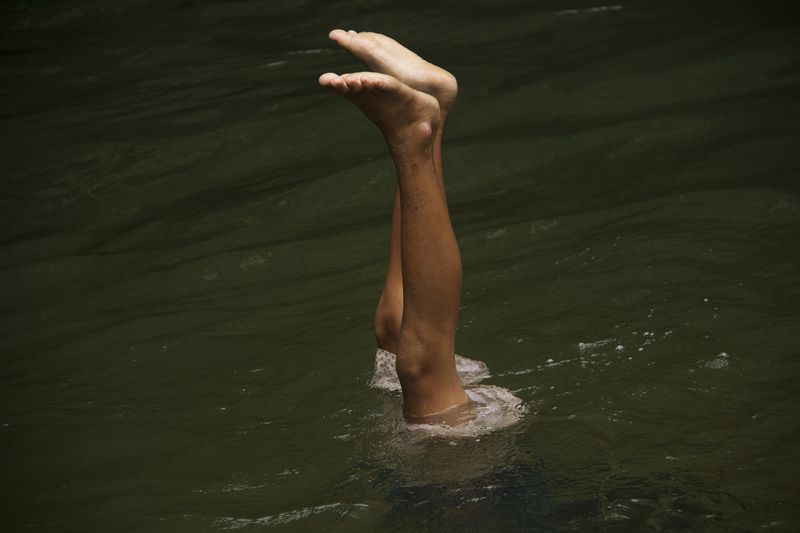© Michael Eko - A boy swims in the An River. Punan Adiu customary forest. 2020.