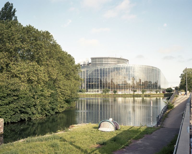 © Tommaso Rada - France, Strasbourg. A tent of a protester is mounted on the other side of the river of the European Parliament.