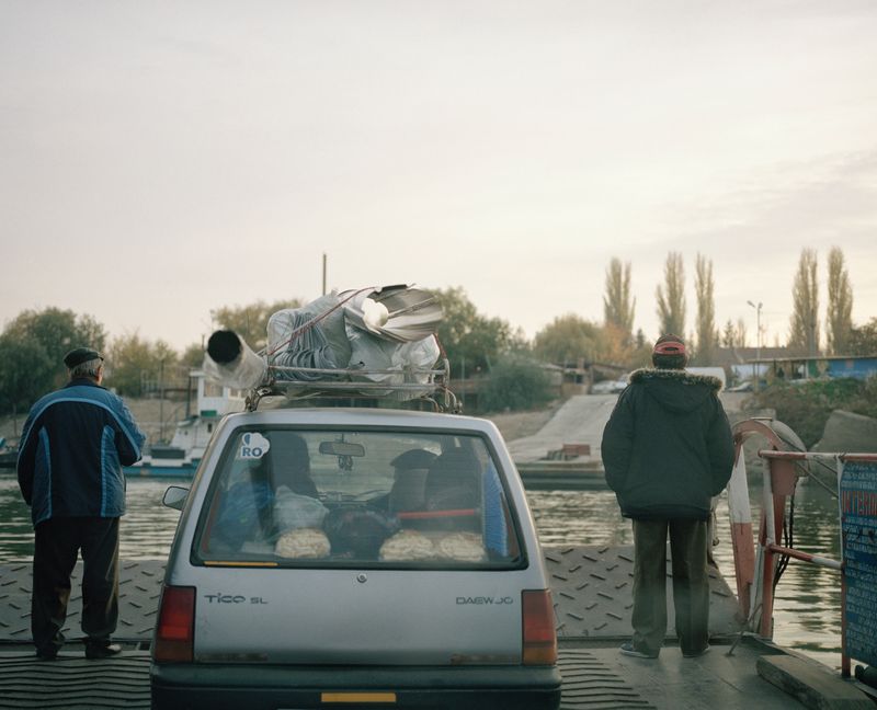 © Tommaso Rada - Romania, Calarasi. A Romanian family cross the Danube in a ferry