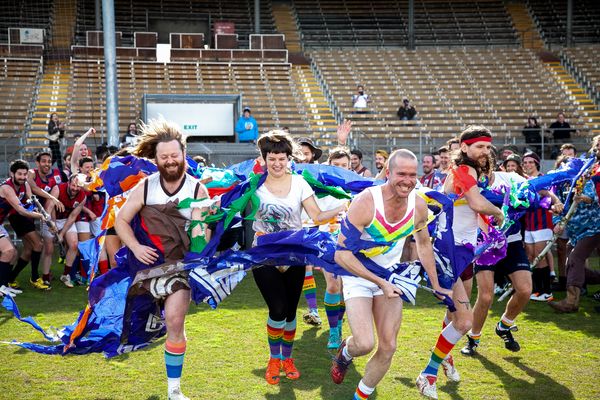 © J Forsyth - The Unicorns run onto the field through a banner before the game