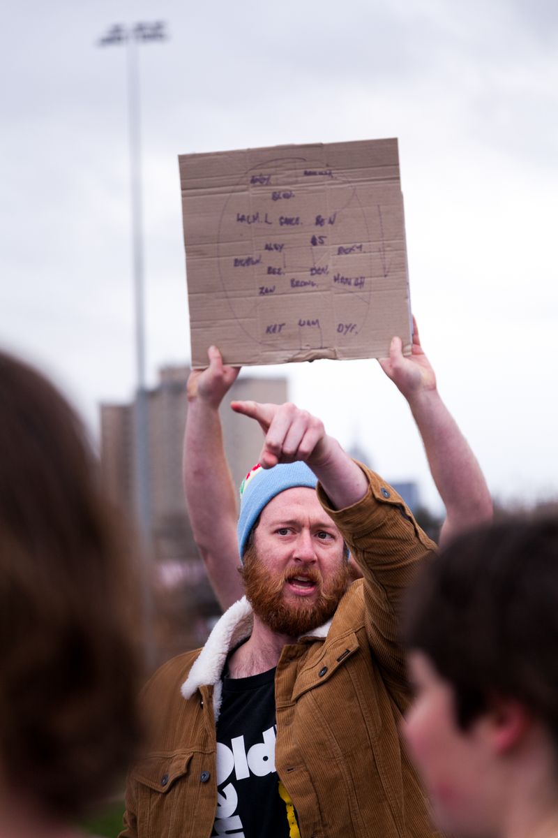 © J Forsyth - Coach talks to the players with the team being held up behind. The team is written on the inside of a beer carton
