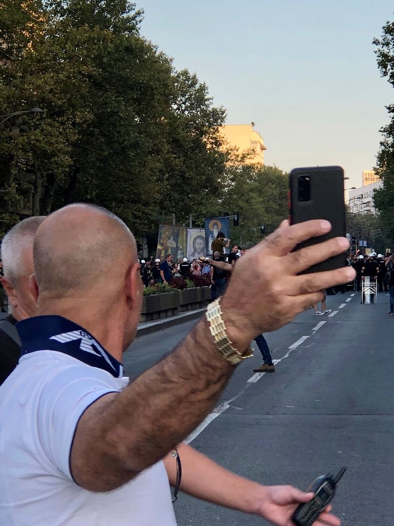 © Filip Bojovic - Undercover policeman at anti Pride protest in Belgrade in front of religious counter-protesters.