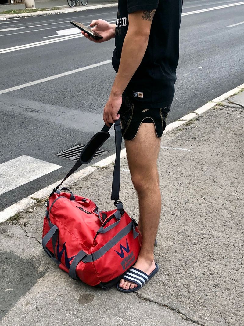 © Filip Bojovic - Boy with phone, after the training, going from the gym.