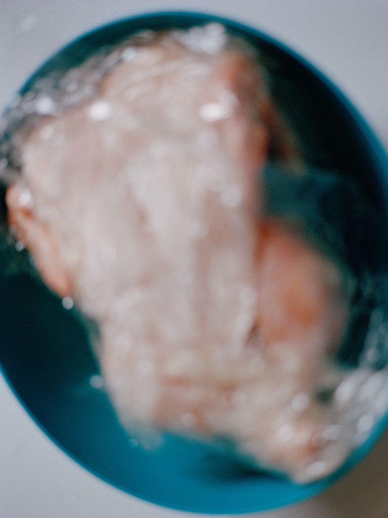 © Victoria Li - A chicken wrapped in cling film, which was being prepared for making a Chinese dish.