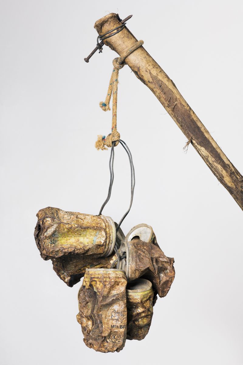 © Silvio Rusmigo - Assemblage of tin cans bundled up at the end of a long stick, used by trappers to startle birds to traps