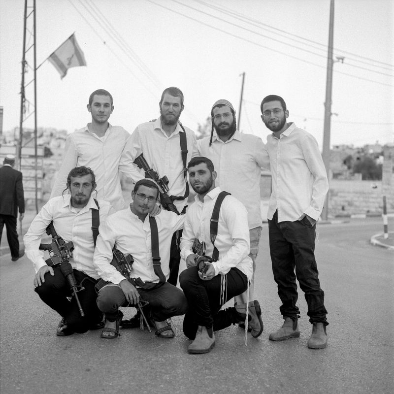 © Fabrizio Bilello - Settlers pose for a portrait. H2, Al-Khalil