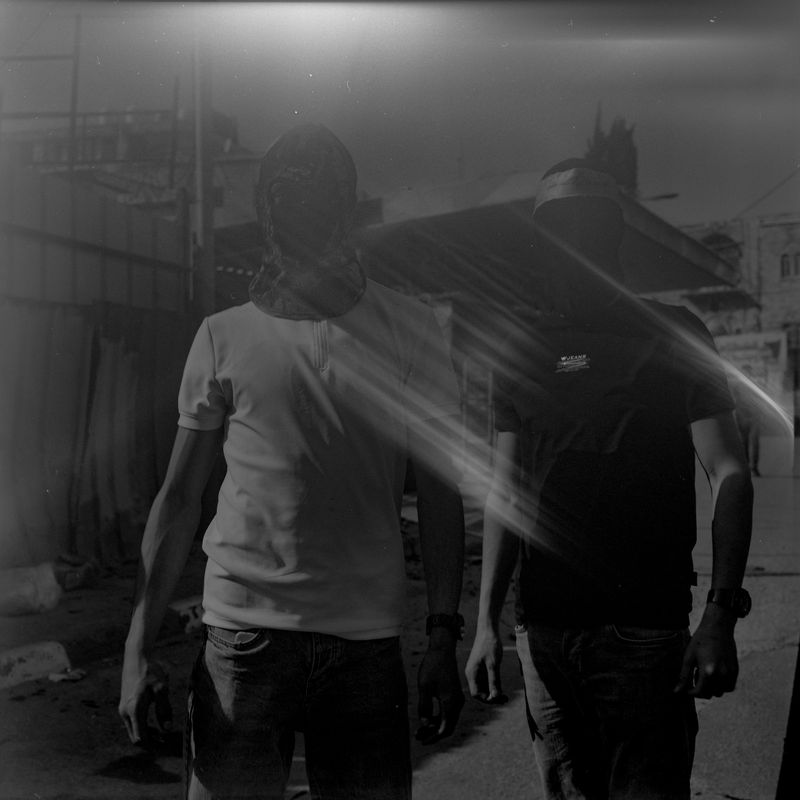 © Fabrizio Bilello - Two Palestinian youths with masks, who confront IOF at the entrance of the checkpoint, pose for a portrait. Hebron, May 2023