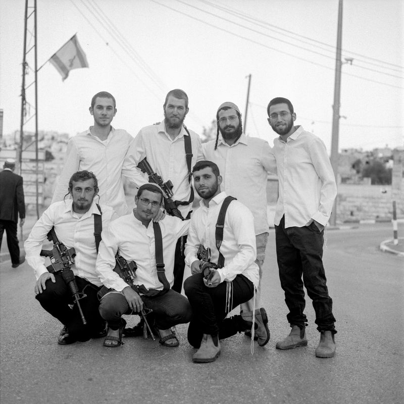 © Fabrizio Bilello - Settlers pose for a group portrait. Hebron, May 2023.