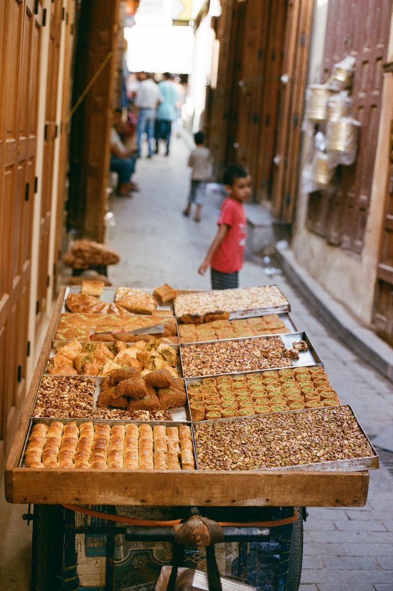 © Annissa Durar - A table of local sweets parked in the middle of the narrow alleyways in the Fez Medina