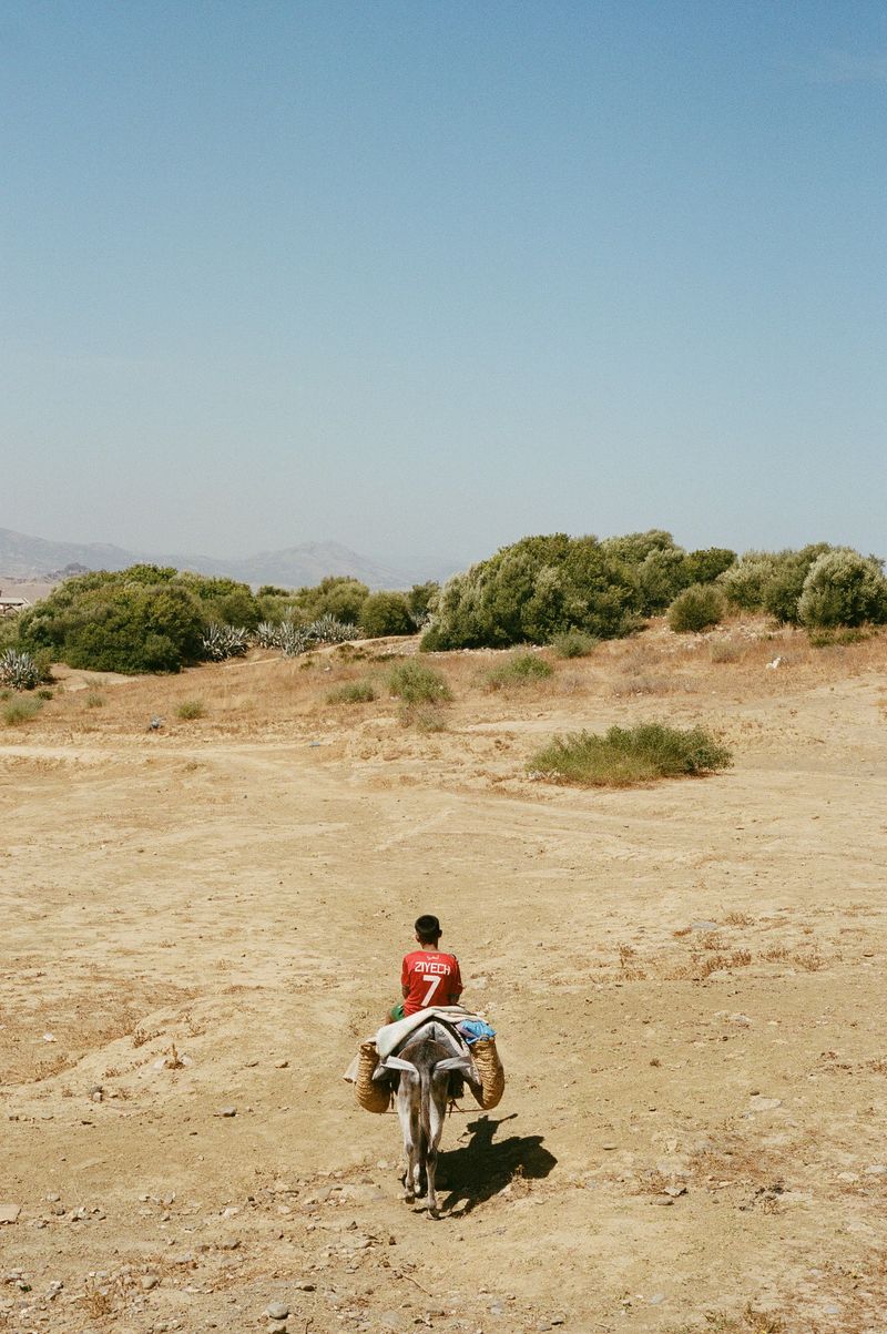 © Annissa Durar - Zhour's son guiding us to their home, carrying clay and his prized Ziyech soccer jersey in tow