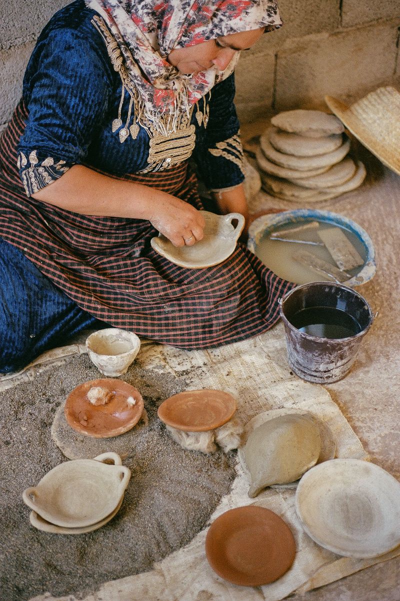 © Annissa Durar - Zhour painting her freshly hand-built pottery with pigment picked from the earth