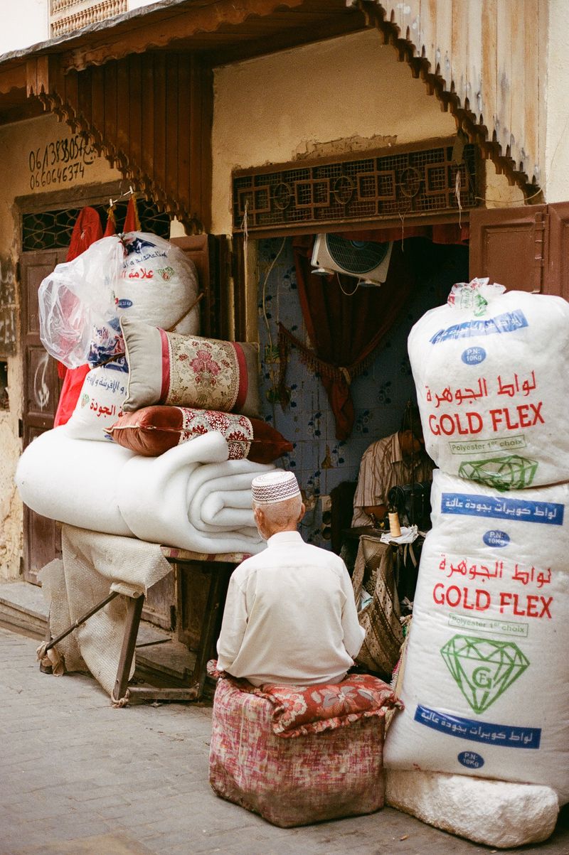 © Annissa Durar - A quiet conversation in a textile shop amidst the bustling Fez Medina