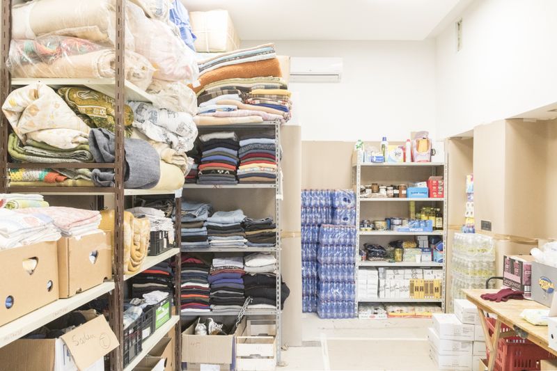 © Manuela Schirra and Fabrizio Giraldi  - Center for the collection of clothing and essential goods managed by Caritas and volunteers.