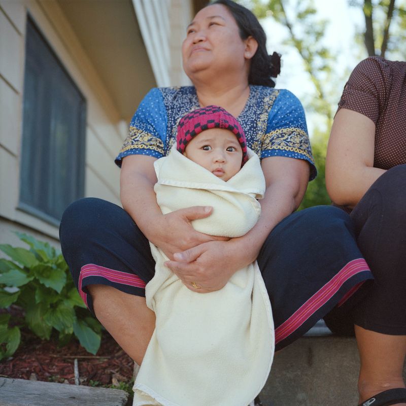 © Selma Fernandez Richter - A Karen grandmother and grandson spend time with neighbors outside on their front step.