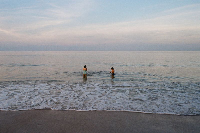 © Rachel Fleischman - Siblings playing in the still summer waters at Vilano Beach. (2025)