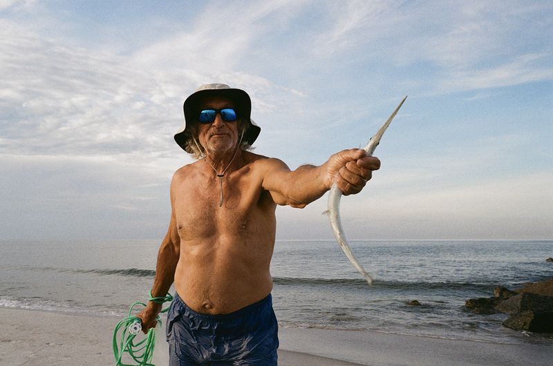 © Rachel Fleischman - The fisherman that fishes for fun and to feed Gordon the egret at Vilano Beach. (2025)