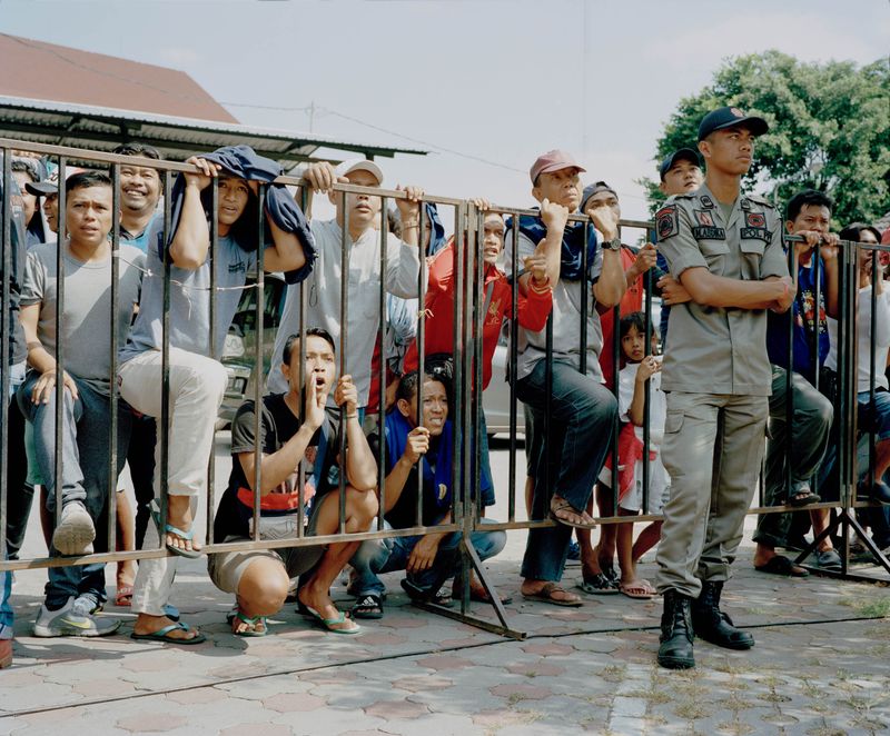© Wilko Meiborg - Crowd and security at a songbird contest. The guards are allowed to disqualify partipiciants for shouting too loud.