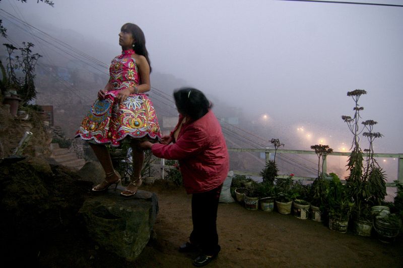 © Max Cabello Orcasitas - Yanet Acuna se prueba el nuevo vestuario de cantante en el patiio de su casa. Su madre la ayuda a probarse la Pollera.