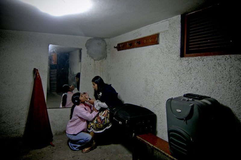 © Max Cabello Orcasitas - Dressing singing. Yanet Acuña is helped to make up by a friend also singer.