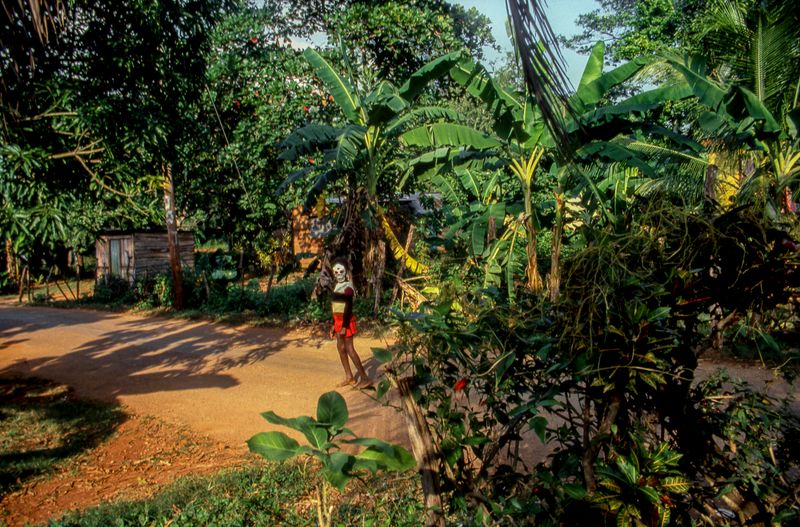 © Steven Edson - Person wearing a skeleton mask on a warm sunny day. Jamaica