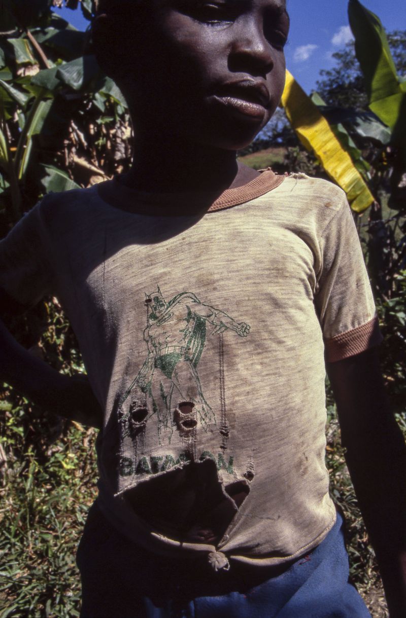 © Steven Edson - Portrait of a boy with tattered Batman t-shirt. Jamaica