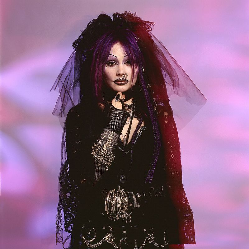 © Steven Edson - Portrait of woman dressed in goth clothing with bracelets and piercings.