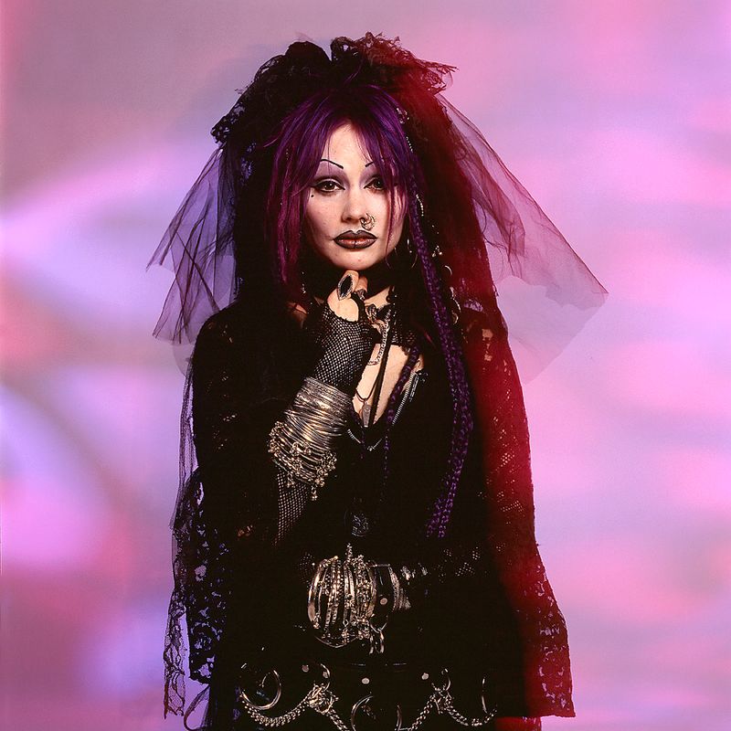 © Steven Edson - Portrait of woman dressed in goth clothing with bracelets and piercings.