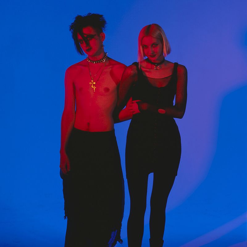 © Steven Edson - Portrait of Goth couple in red light against a blue background