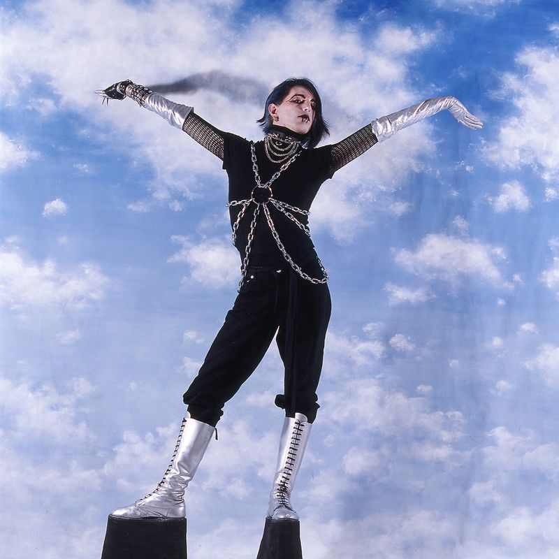 © Steven Edson - Young man dressed in Goth clothing wearing very high platform shoes