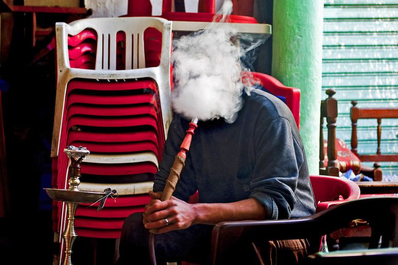 © Steven Edson - Man smoking shisha at the cafe. Tripoli Libya.