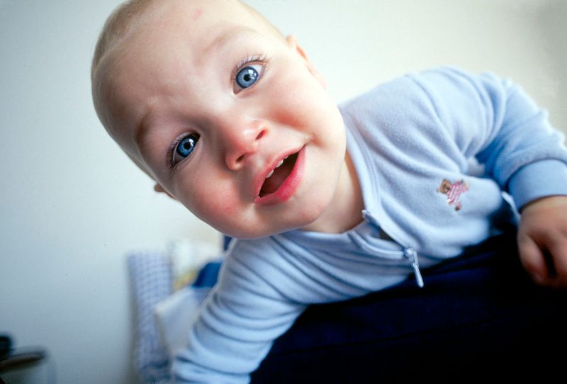 © Steven Edson - Small child looking peering over the chair to get a closer look.
