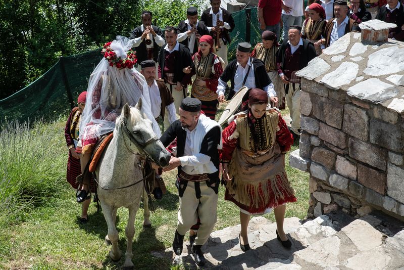 © Biljana Jurukovski - The bride is taken by the groom and his best man on a horse in the tradional way