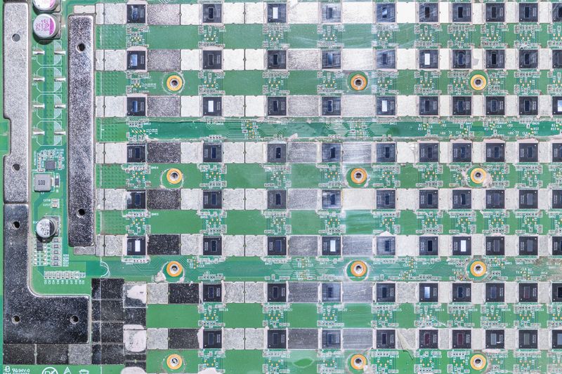© Enka Springub - Hashboard from a Bitcoin mining computer. Each square contains a microchip. A typical miner contains three such boards.