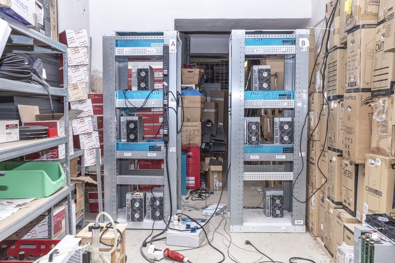 © Enka Springub - Mining devices being tested in the basement of a computer shop that sells mining equipment in Prague, Czech Republic.