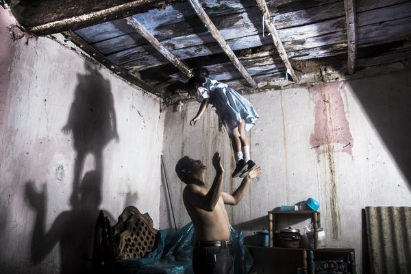 © Yael Martínez - The house that bleeds(self portrait with my daughter and apresence of a hanging man) Guerrero Mexico