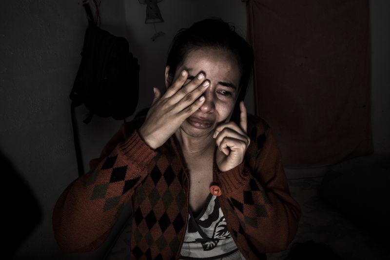 © Yael Martínez - The callLucero Granda taking the call where her mother tell her that her brother was killed, at Iguala Guerrero