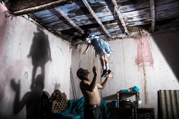 © Yael Martínez - The house that bleeds (self portrait with my daughter and apresence of a hanging man) Guerrero Mexico