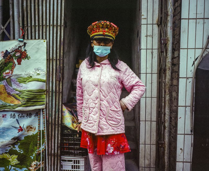 © Pan Wang - A man in a woman's dress stood in the Xicang market