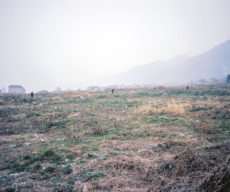 © Pan Wang - 13.On the farmland requisitioned for commercial development, construction workers are measuring the land
