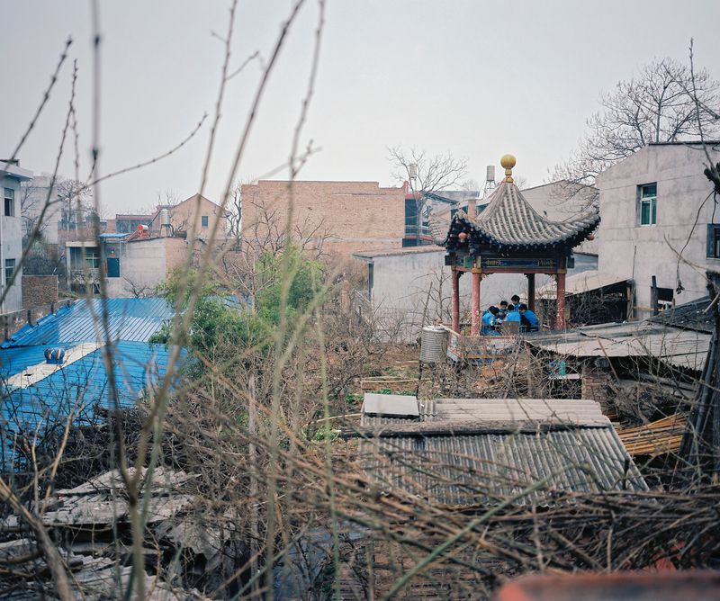 © Pan Wang - 15. Students playing mahjong in the pavilion during lunchtime