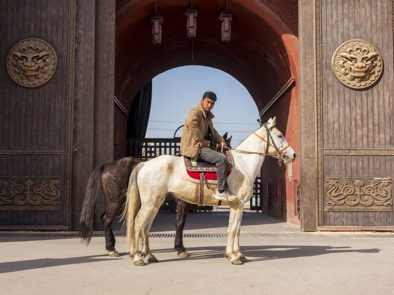 © Pan Wang - A young man riding a horse.in Yotkan Ancient City, Xinjiang Uygur Autonomous Region, China, October 25, 2025.