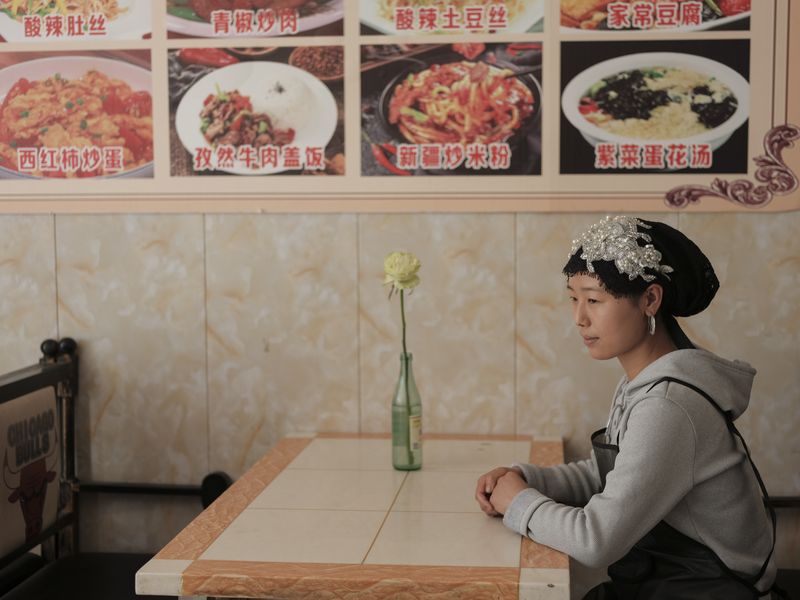 © Pan Wang - May 13, 2025, in Yumen City, Gansu Province, China, a young woman running a restaurant.